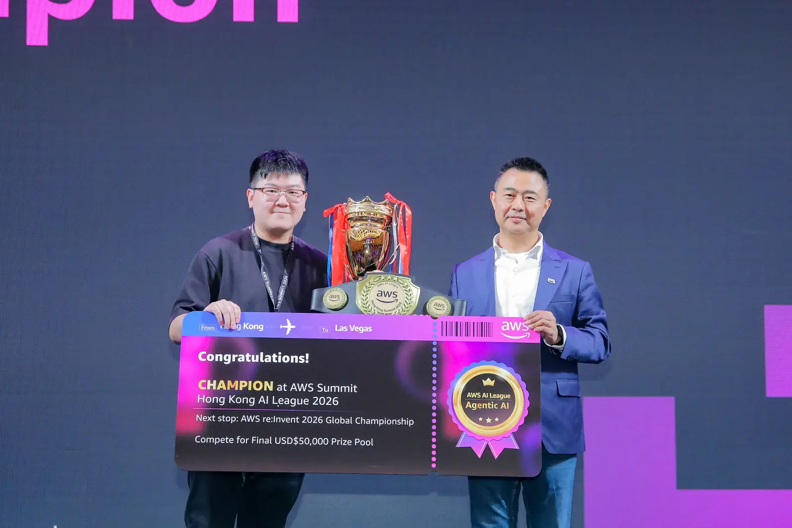 Max Chui receiving the AWS AI League Hong Kong Champion boarding-pass award on stage from Chu Ruisong, Corporate VP & President of AWS Greater China