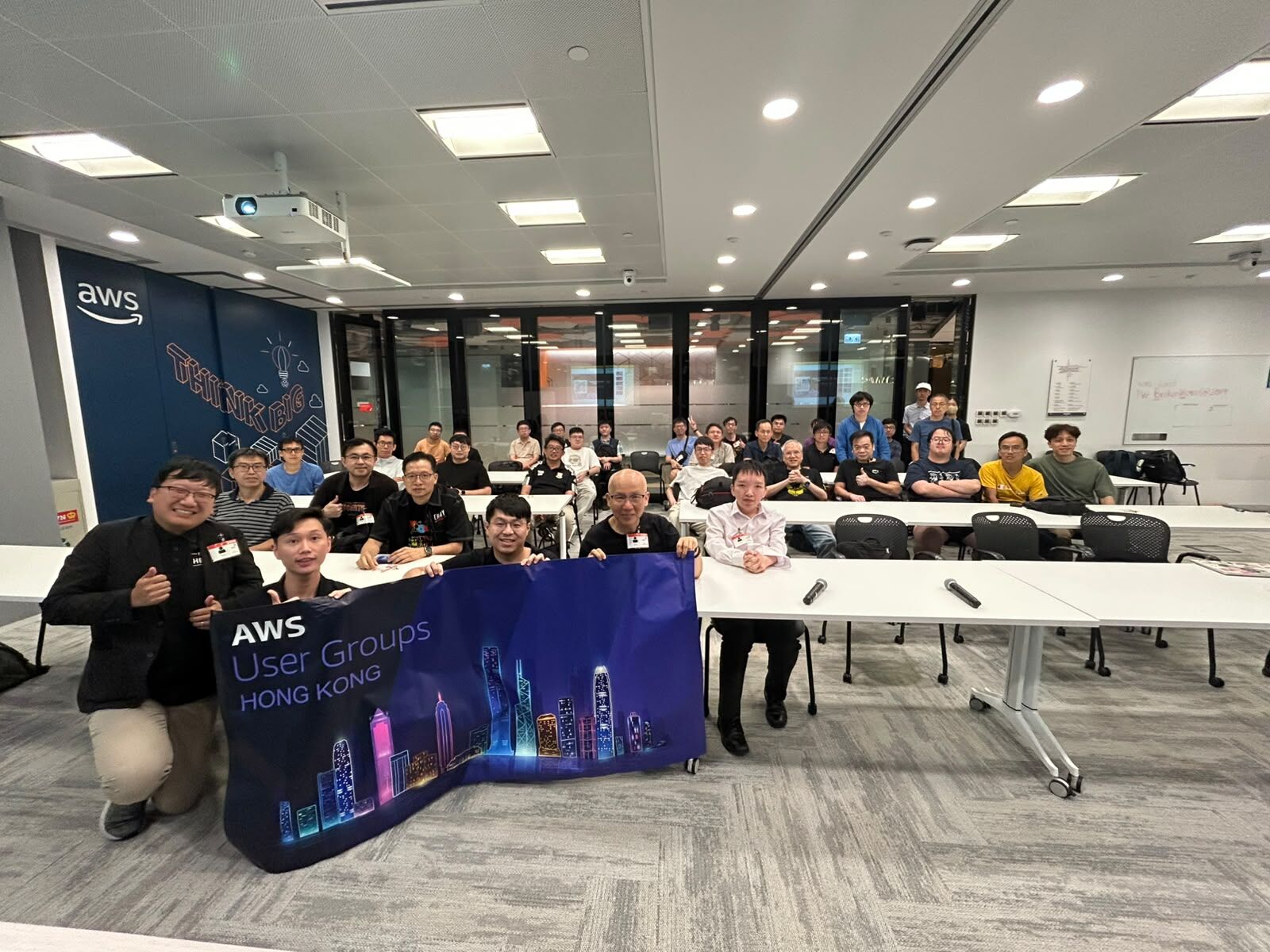 AWS User Group Hong Kong meetup attendees posing with the user group banner